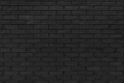 A black brick wall. Dark surface texture. Architectural building background