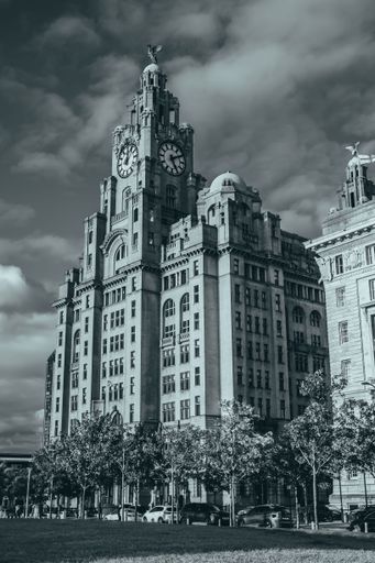 A vertical greyscale of the Liver Building in the city of Liverpool