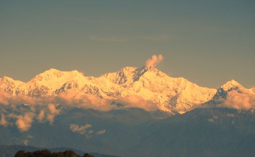 A Tiger Hill view with purple, snowy pointed tops at sunset, skyline background, Darjeeling