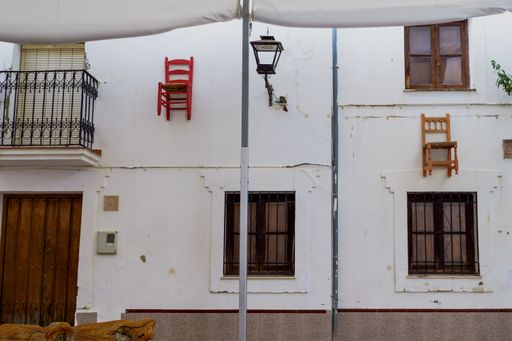 10-05-2022 parauta malaga , curious chairs hung on the walls of the houses tradition