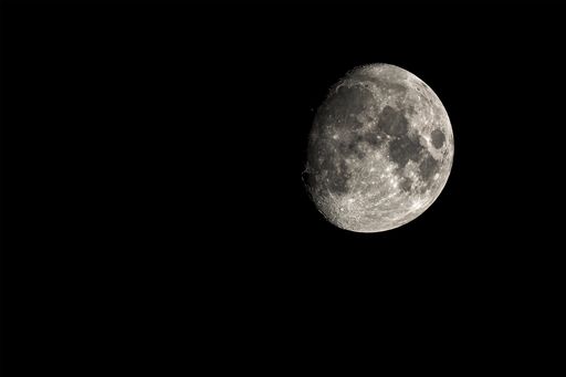A mesmerizing view of a moon in the dark black sky at night
