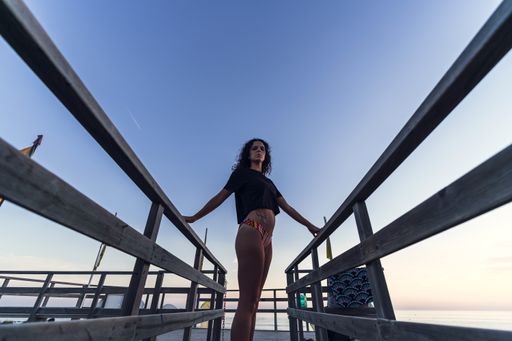 A young beautiful woman wears a swimming suit enjoys a day