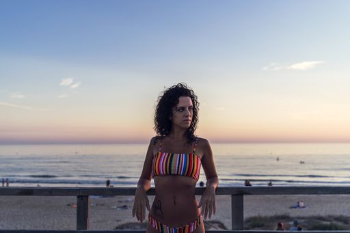 A young beautiful woman wears a swimming suit enjoys a day