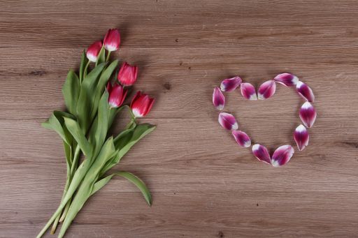 A top view of beautiful pink tulips on the wooden table