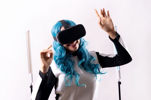A female with blue hair and virtual reality glasses- a futuristic concept