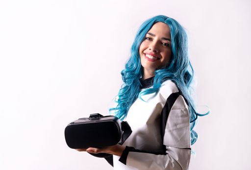 A female with blue hair and virtual reality glasses- a futuristic concept