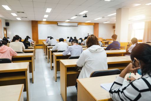 A view of students writing final examination papers in the classroom