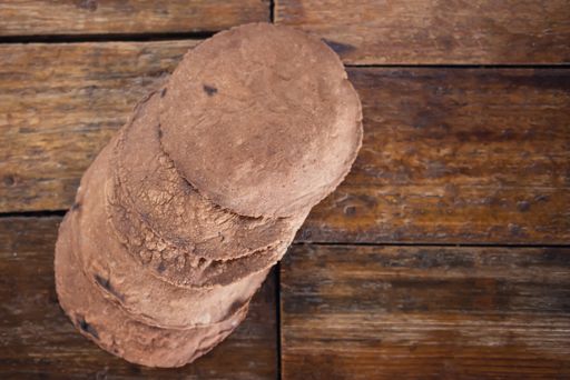 A top view of brown tortillas on a wooden surface