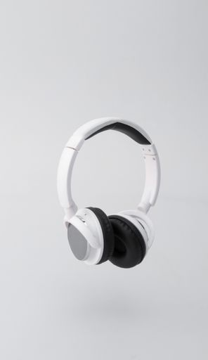 A vertical shot of white headphone isolated on a white background