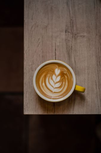 A vertical top view of a cappuccino in a cup