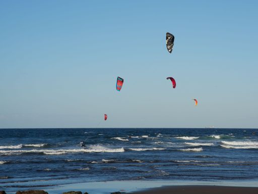 A beautiful view of kitesurfing over the sea in Telde, Gran Canaria, Canary Islands.
