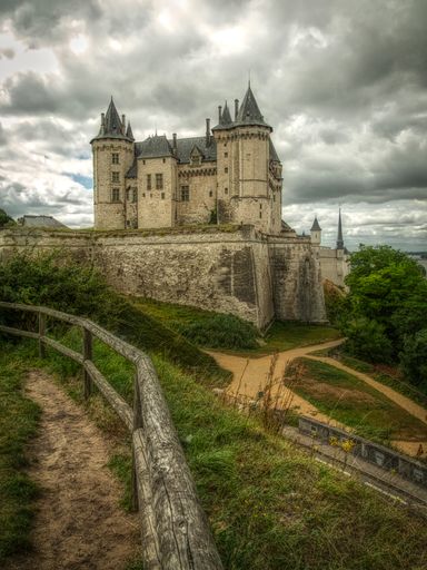 A vertical shot of the famous castle of Saumur in France under the cloudy sky