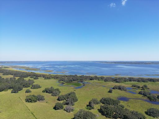 A top view of the lake Lake Tohopekaliga and surrounding fields in Florida
