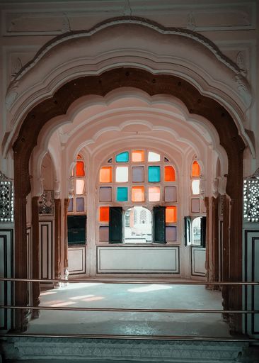 A vertical shot of colorful windows of inner part of the Hawa Mahal Palace in Jaipur, Rajasthan, India