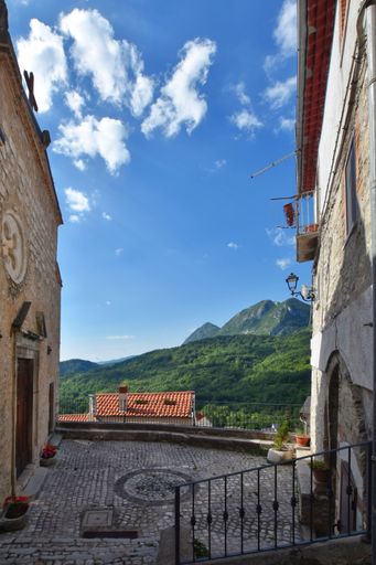 A narrow street between the old stone houses of Pizzone, a medieval village in the Molise region of Italy.