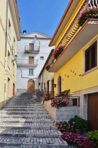 A narrow street between the old stone houses of Pizzone, a medieval village in the Molise region of Italy.