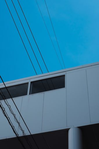 A vertical shot of a white building and the sky at nighttime