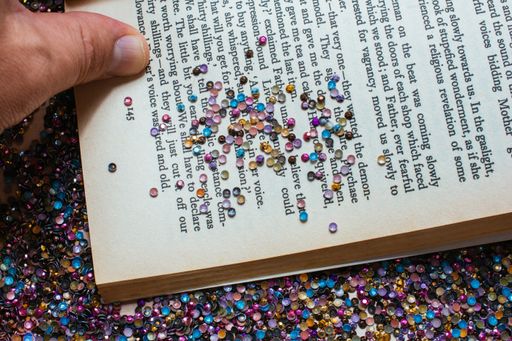 A closeup shot of a book page sprinkled with glitters