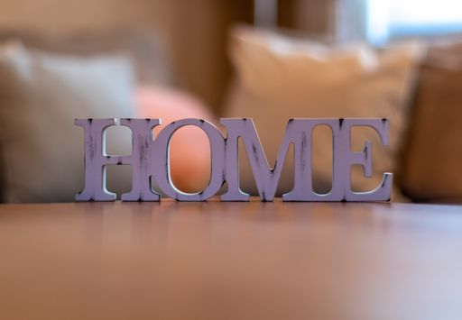 A closeup shot of a purple home lettering on a wooden surface