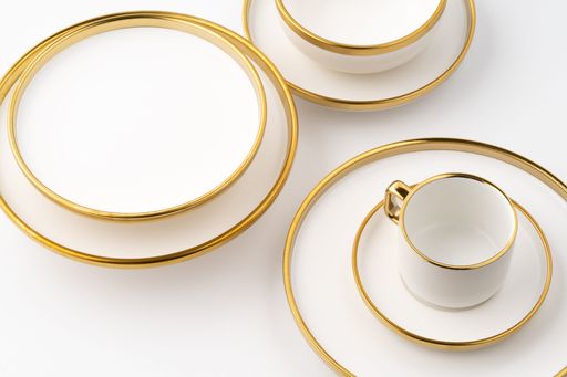 A set of white and brown ceramic plate and cup on a white background