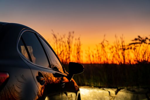 A shiny black car with a beautiful sunset at the Shenandoah Mountains in Virginia, USA