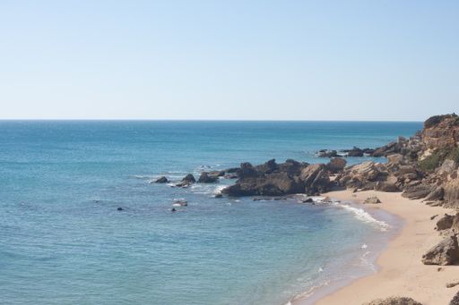 A beautiful view of a sandy shore with a clear skyline