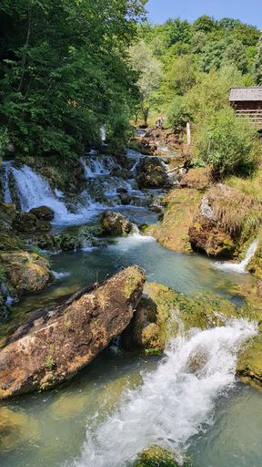 a Vertical shot of a cascade with rocks in nature