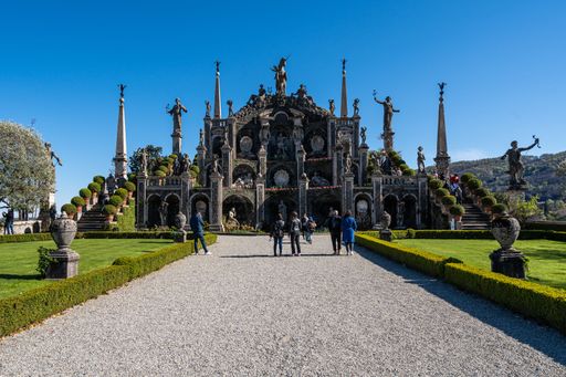 The Teatro Massimo monument with people walking in front of it in the garden of Bella Island, Stresa, Italy