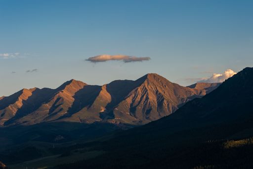 An aerial view of beautiful mountains against a cloudy sky during the sunrise in Xinjiang, China
