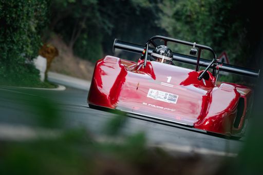 A Ferrari red racing car on the road in San Bartolo park. Pesaro, Italy.