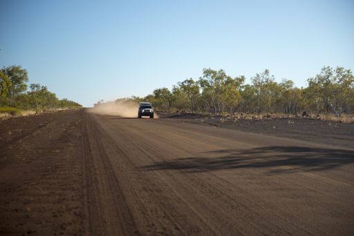SUV or four by four vehicles on a long dusty dirt road