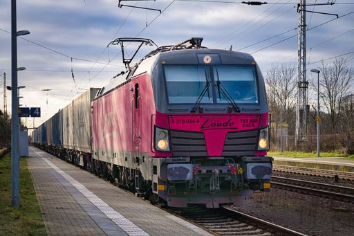 An electric locomotive, Siemens Vectron from Laude carrying a freight train with containers through Priort, Germany