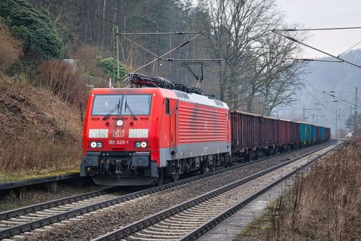 A DB Cargo class 189 electric locomotive carrying a freight train through the Elbe valley to Bad Schandau