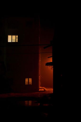 A vertical shot of residential building blocks in an urban area at night