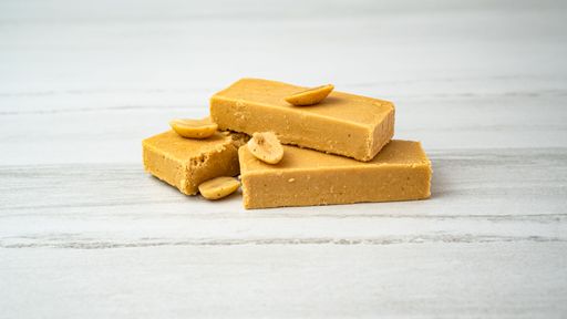 A closeup of a soft nougat bar made with peanuts and honey to create turron perfection