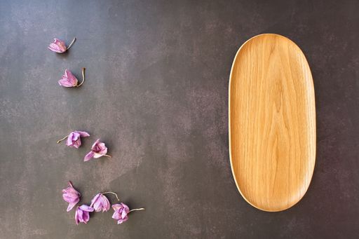 A top view of a rustic wooden tray decorated with dried lavender flowers