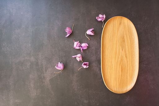 A top view of a rustic wooden tray decorated with dried lavender flowers