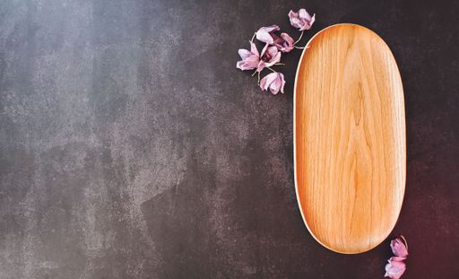 A top view of a rustic wooden tray decorated with dried lavender flowers
