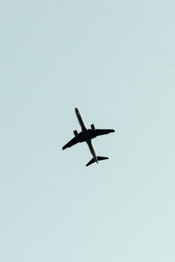 A beautiful vertical view of an airplane flying in a clear sky