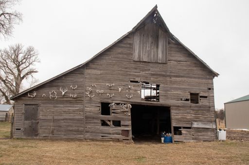 A selective focus shot of an old weathered barn