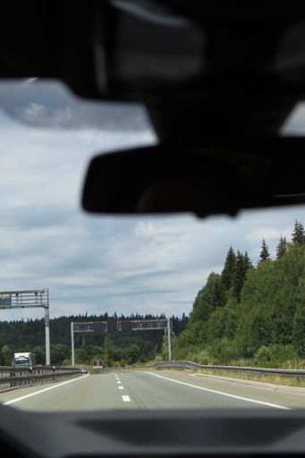 A vertical shot of a road seen from the car