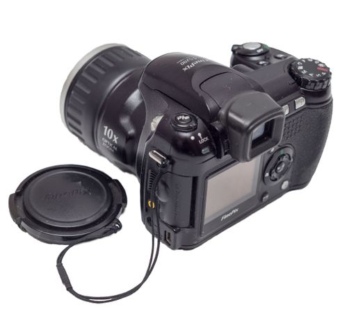 An old 2005 digital camera with missing Fujifilm FinePix S5200 isolated on a white background