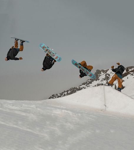 A snowboarder doing backflip freestyle snowboarding on the snow-covered slope of Les Arcs, France