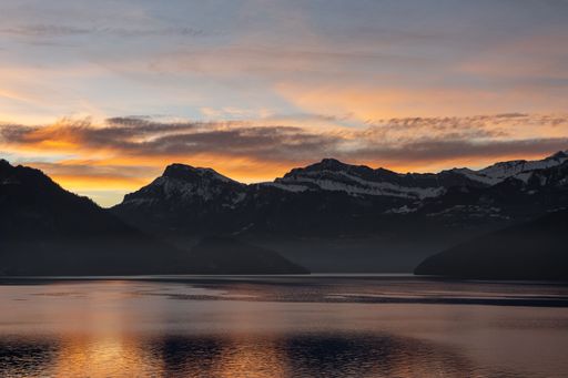 Beautiful sunset behind the mountions at the lake lucerne with some clouds