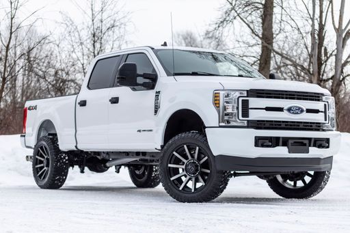 The white Ford super duty leveled on 35s during the winter.
