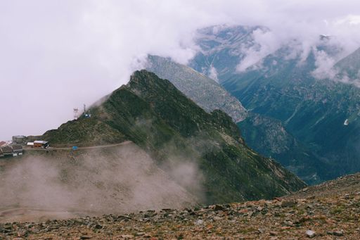 A beautiful view of mountains with clouds over them.