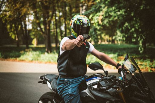 Assassin on the motorcycle is holding gun, the crime scene