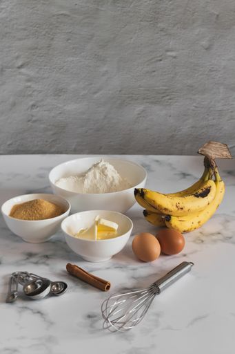 A vertical shot of ingredients for baking banana bread in the kitchen