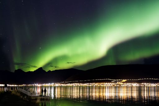 The Northern Lights over the mountains in Norway during the stary night