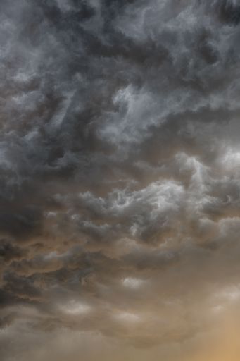 A vertical shot of a cloudy dark sky